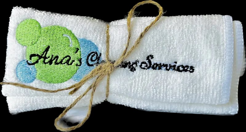 Blue microfiber cleaning cloth with Ana's Cleaning Services branding, folded neatly on a light surface