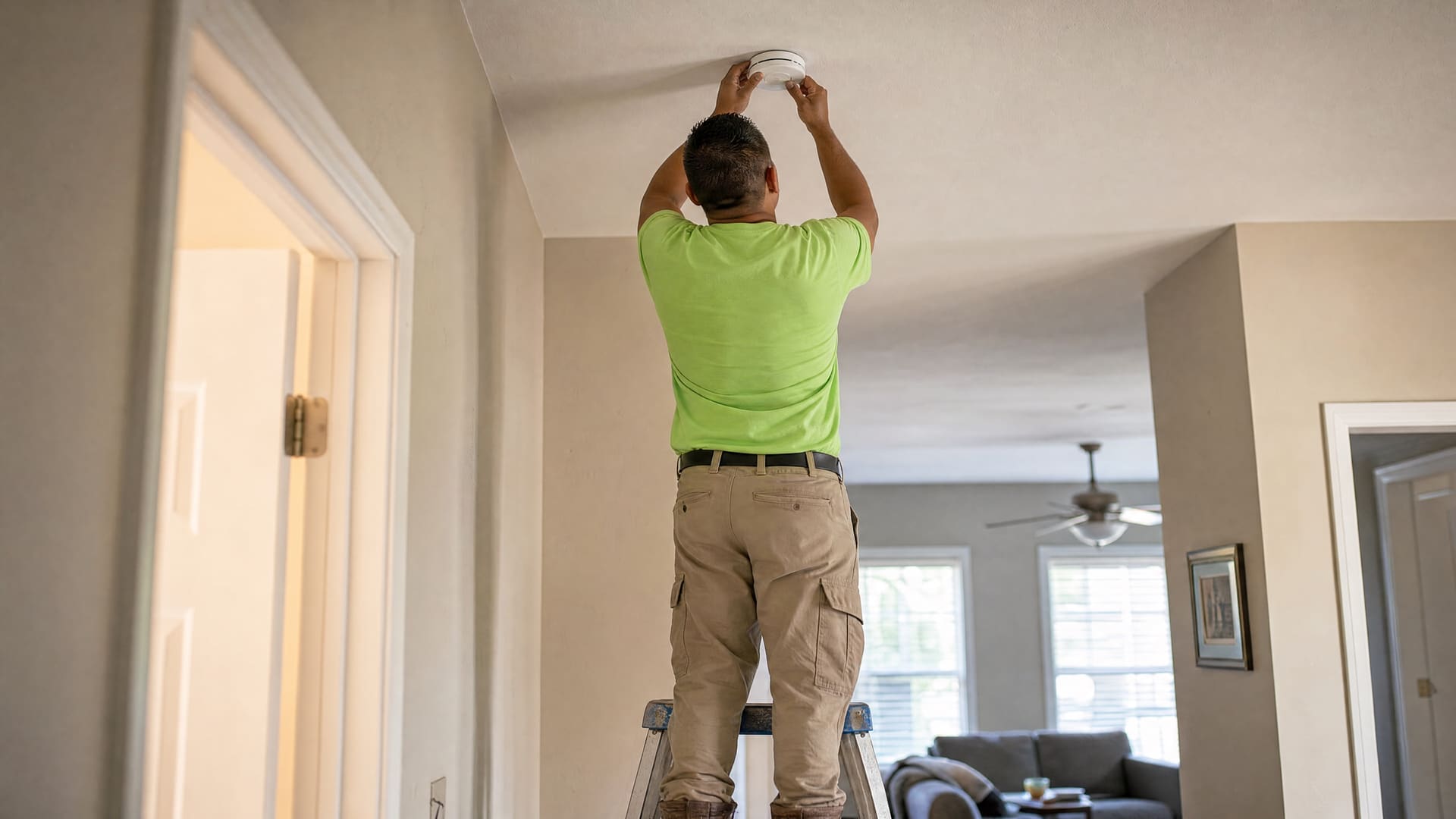 OPH contractor reattaching a smoke alarm to the ceiling during a scheduled AnaCare visit